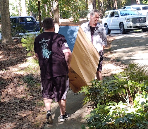 Workers hauling furniture